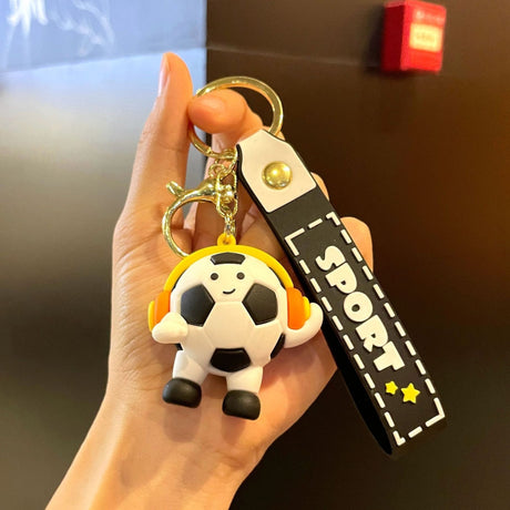 Breloc Flippy din acril negru, design minge de fotbal cu căști, detaliu cureluță prindere